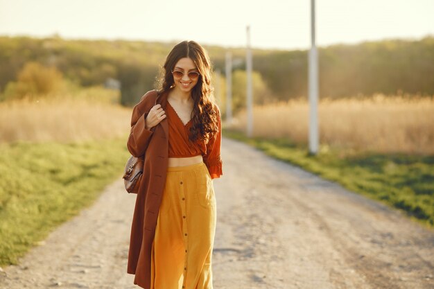 Stylish woman spending time in a summer field