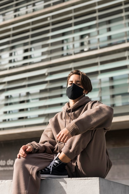 Stylish woman wearing a medical mask outside