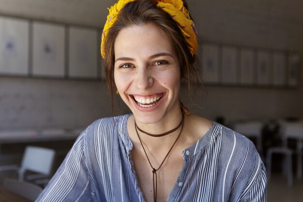 Stylish woman wearing yellow bandana