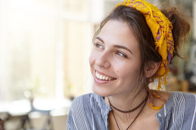 Stylish woman wearing yellow bandana