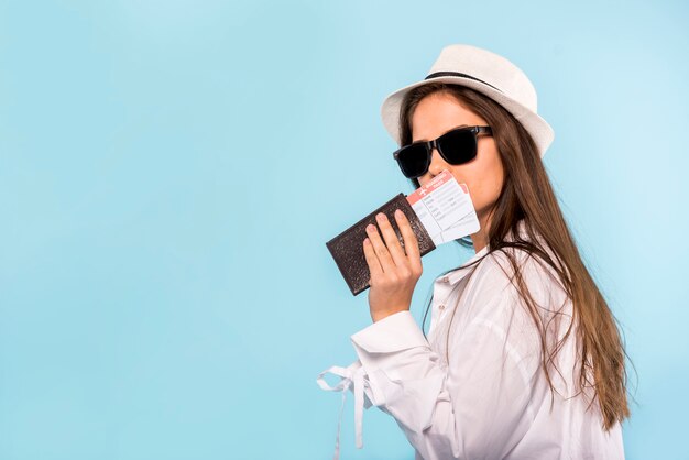 Stylish woman with passport and tickets
