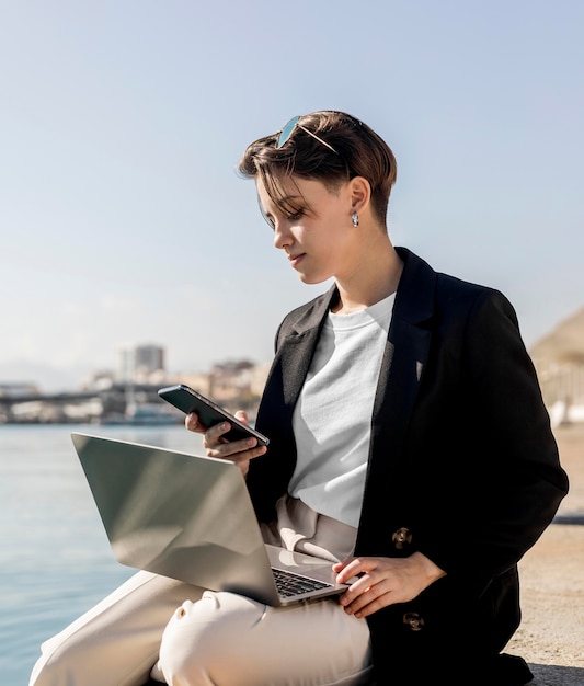 Stylish woman working outside on a sunny day