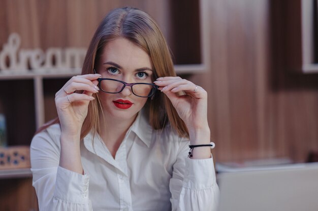 Stylish woman works at a laptop desk in a modern office