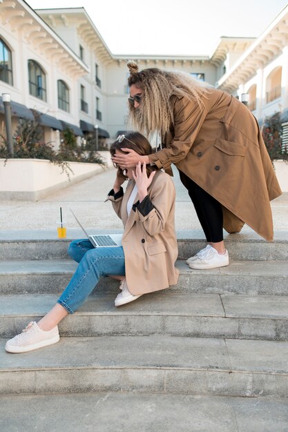 Stylish women relaxing outdoors