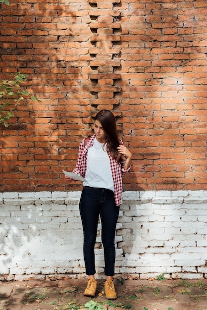 Free photo stylish young girl checking a map