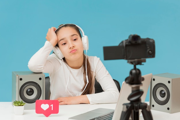 Stylish young girl recording video