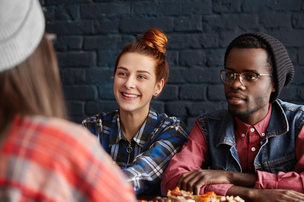 Free photo stylish young interracial couple having lunch at restaurant