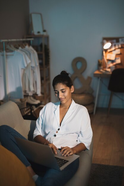 Stylish young lady working on laptop