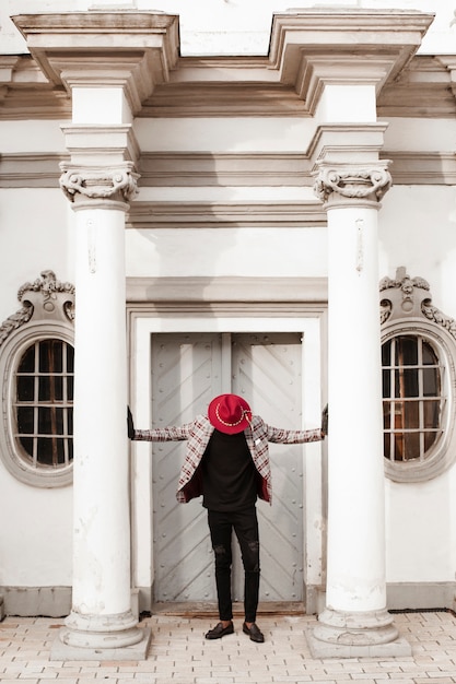 Stylish young male with hat posing outdoors