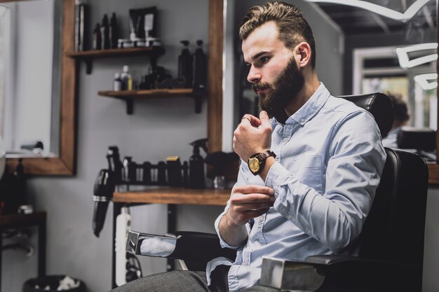 Stylish young man in barbershop