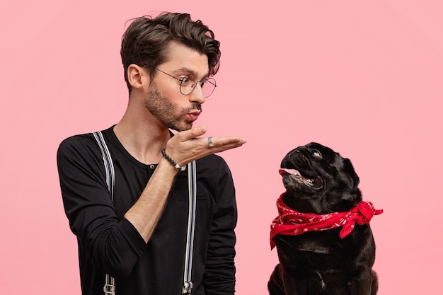 Stylish young man and his cute dog