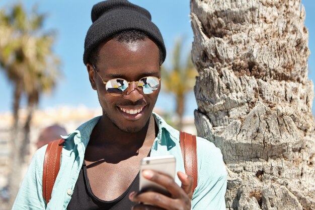 Stylish young man looking through videos on social media