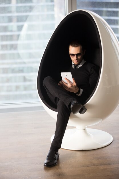 Stylish young man shopping online with tablet