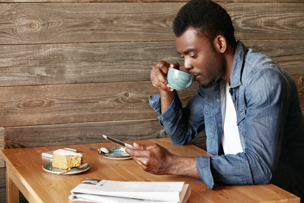 Stylish young man sitting in cafe