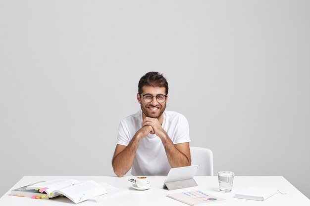 Stylish young man sitting at desk