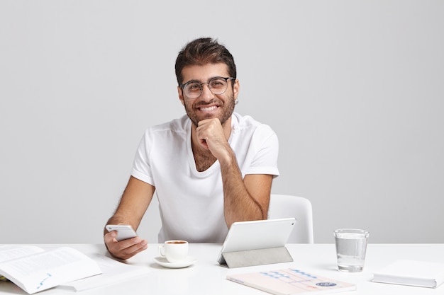 Stylish young man sitting at desk