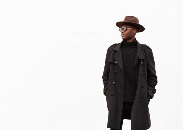 Stylish young man with sunglasses and hat