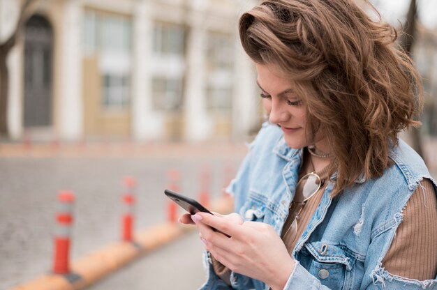 Stylish young teenager browsing mobile phone