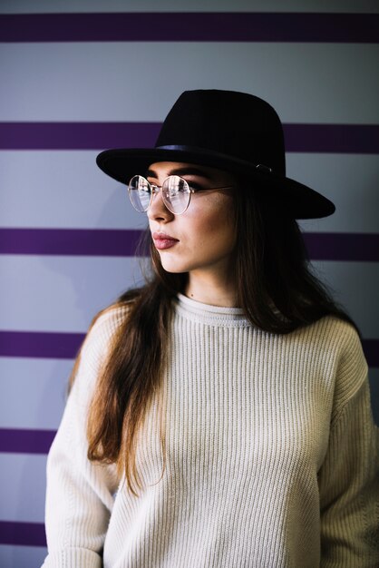 stylish young woman in hat and eyeglasses
