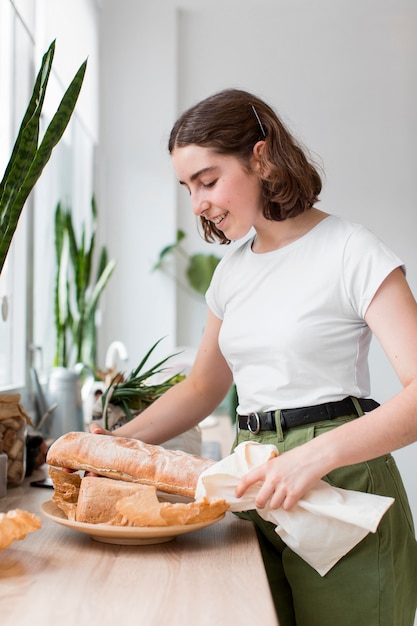 Stylish young woman holding organic bread