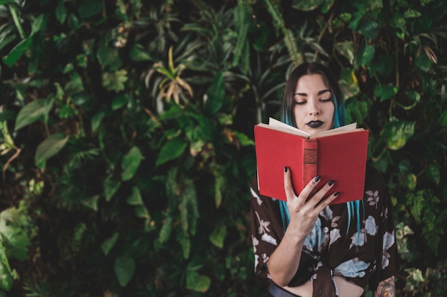 Stylish young woman reading book