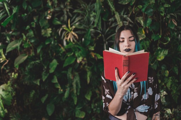 stylish young woman reading book