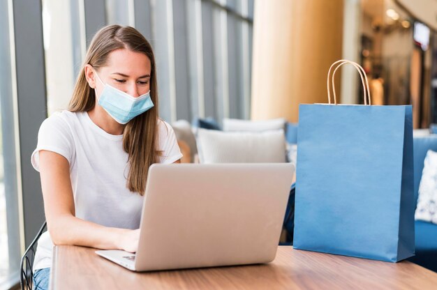 Stylish young woman wearing face mask