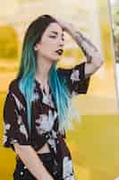 Free photo stylish young woman with tattoo on her hand