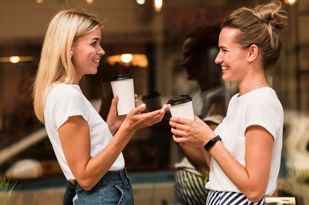 Stylish young women enjoying coffee together