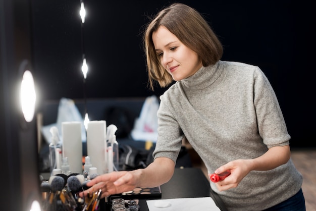 Free photo stylist choosing brushes on table