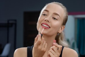 Free photo stylist keeping lipstick and doing makeup