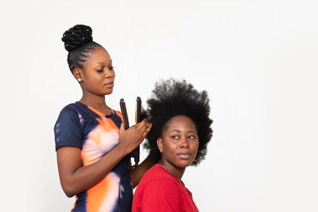 Stylist woman taking care of her client afro hair