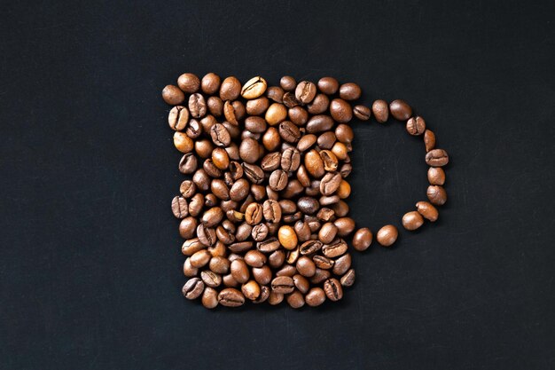 Stylized cup of coffee out of coffee beans flat lay
