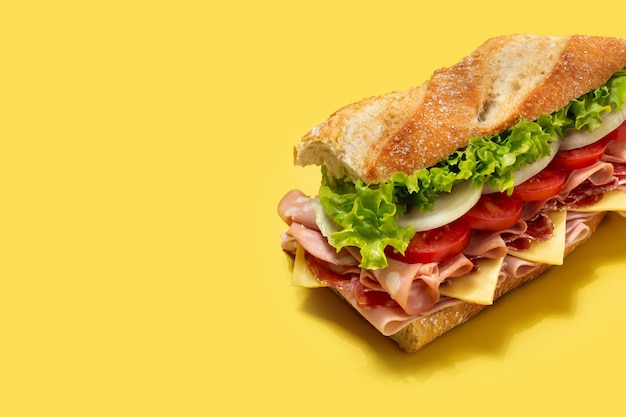 Submarine sandwich with ham cheese lettuce tomatoesonion mortadella and sausage