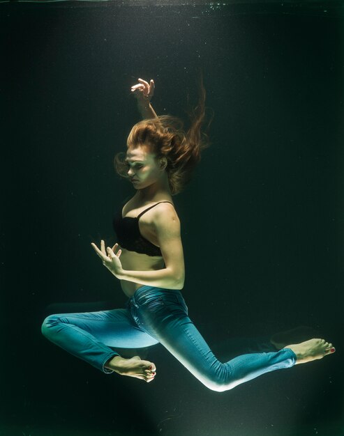 Submerged woman posing in jeans