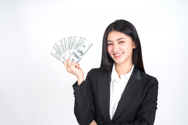 Successful beautiful Asian business young woman holding money US dollar bills in hand 