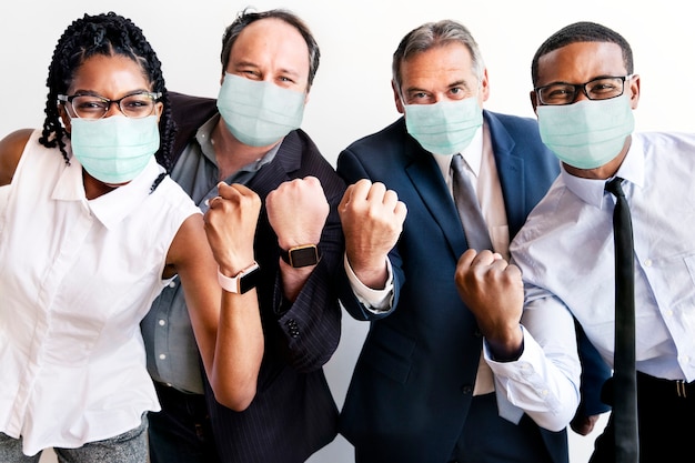 Free photo successful business people wearing face masks at work