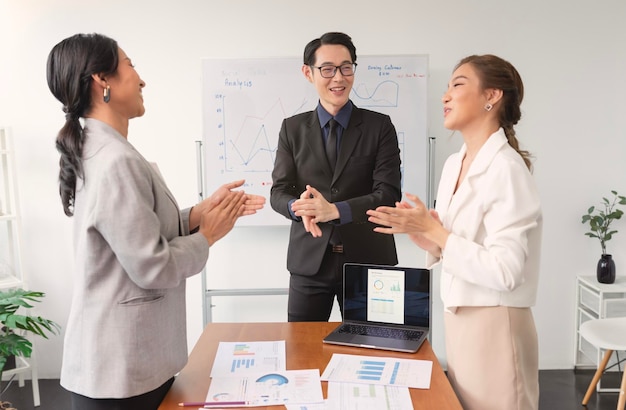 Free photo successful business team is clapping their hands asian businesspeople celebration