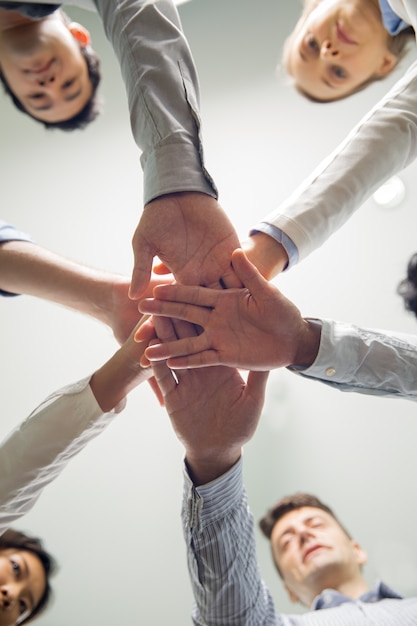 Successful business team stacking hands