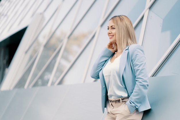 Free photo successful business woman in blue suit