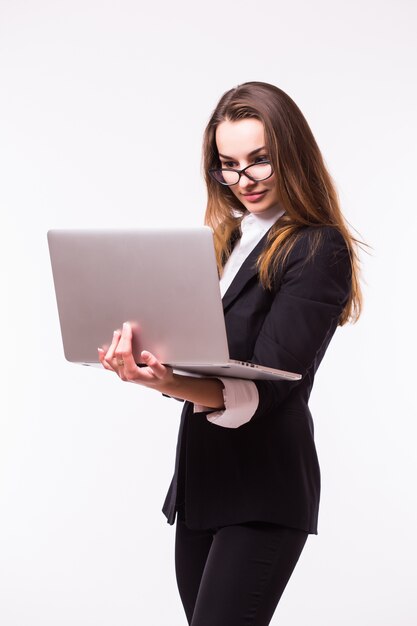 Successful business woman is standing on isolated wall.