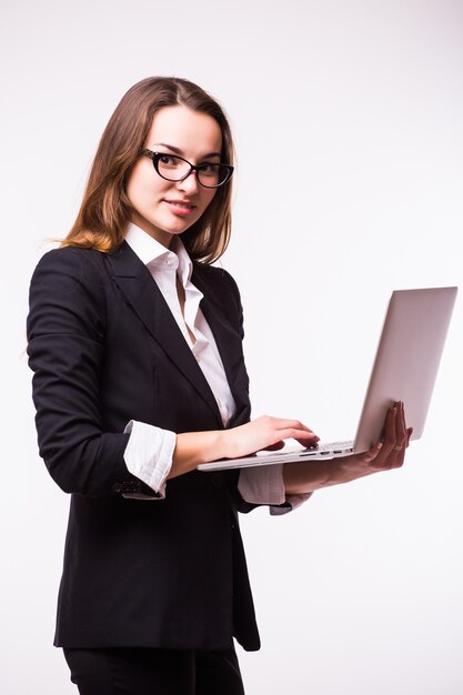 Successful business woman is standing on isolated wall.