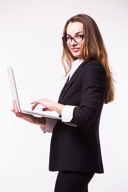 Successful business woman is standing on isolated wall.