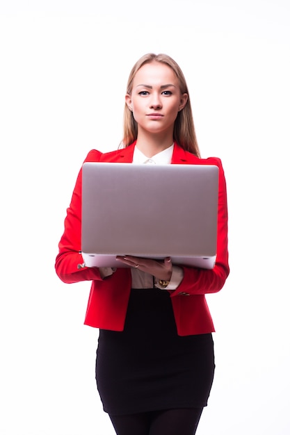 Successful business woman is standing on isolated white wall.