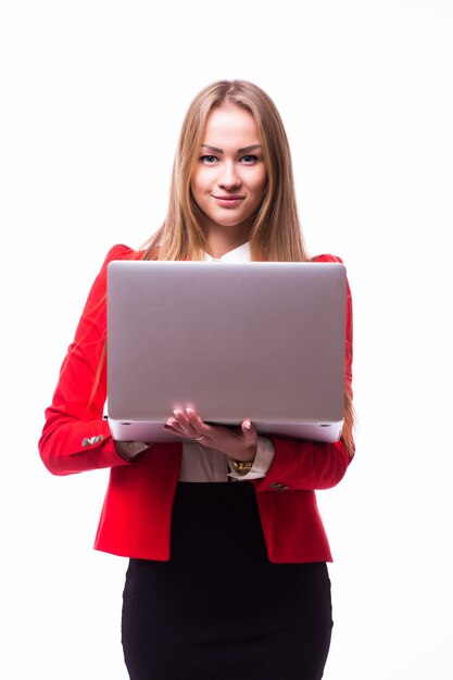 Successful business woman is standing on isolated white wall.