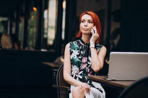 Successful business woman working on laptop in a cafe