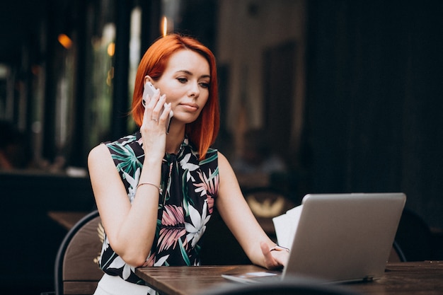 Successful business woman working on laptop in a cafe