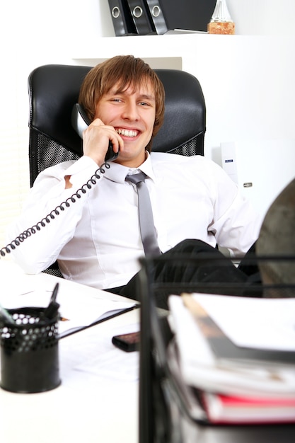 Free photo successful businessman talking by phone