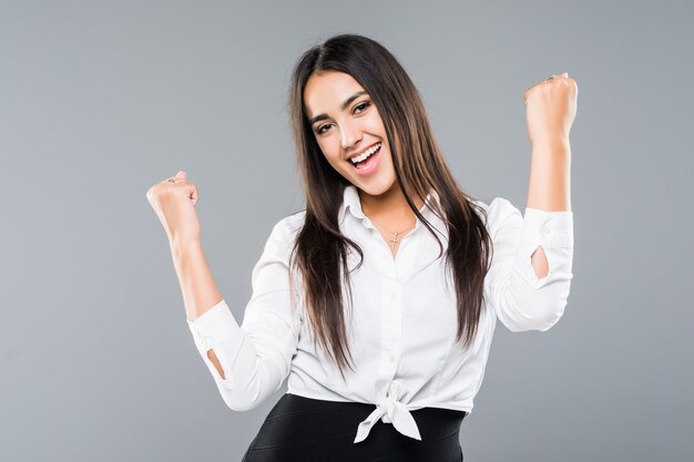 Successful businesswoman with arms up isolated on a on white