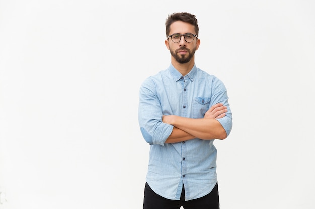 Successful confident male entrepreneur posing with arms folded